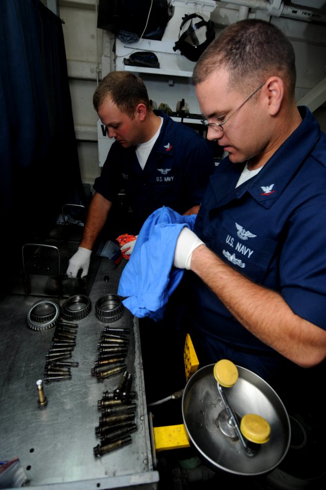 US Navy 090513-N-3946H-015 PACIFIC OCEAN (May 13, 2009) Aviation Structural Mechanic 3rd Class Trever Petre and Aviation Structural Mechanic 2nd Class Daniel Ussery prepare aircraft tire bolts and bearings for inspection