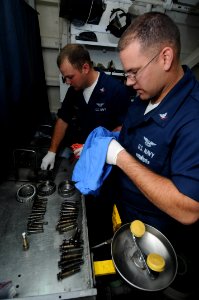 US Navy 090513-N-3946H-015 PACIFIC OCEAN (May 13, 2009) Aviation Structural Mechanic 3rd Class Trever Petre and Aviation Structural Mechanic 2nd Class Daniel Ussery prepare aircraft tire bolts and bearings for inspection photo