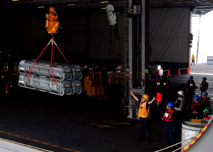 US Navy 090511-N-6233C-012 Boatswain's Mate 3rd Class Elliot Powers gives a safe distance signal during a munitions transfer from the Military Sealift Command dry cargo-ammunition ship USNS Alan Shepard (T-AKE 3) to the aircraf