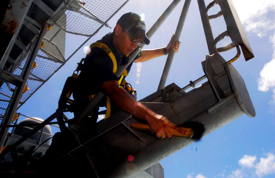 US Navy 090516-N-2475A-098 Electronics Technician 3rd Class John Cesena, from Visalia, Calif., cleans the SPN-41 azimuth radar antennae on the fantail of the aircraft carrier USS John C. Stennis (CVN 74)