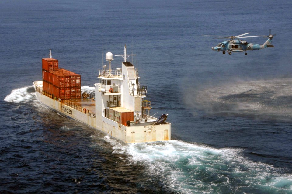 US Navy 090514-N-3946H-110 An HH-60H Seahawk, assigned to the Indians of Helicopter Anti-Submarine Squadron Six (HS-6), approaches a cargo ship to retrieve Explosive Ordnance Disposal (EOD) Technicians