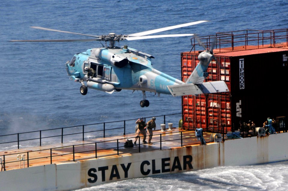 US Navy 090514-N-3946H-124 Explosive Ordnance Disposal (EOD) Technicians, attached to EOD Mobile Unit Eleven (EODMU-11) Platoon 1131, prepare to be hoisted aboard an HH-60H Seahawk