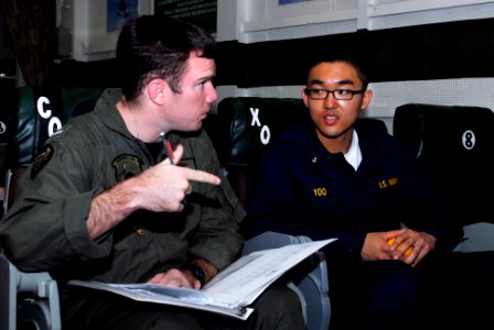 US Navy 090516-N-9610C-043 Lt. j.g. Matt Bettencourt, copilot of an MH-60S Sea Hawk helicopter assigned to Helicopter Anti-submarine Squadron (HS) 8, explains his job to Midshipman 2nd Class Charles Yoo