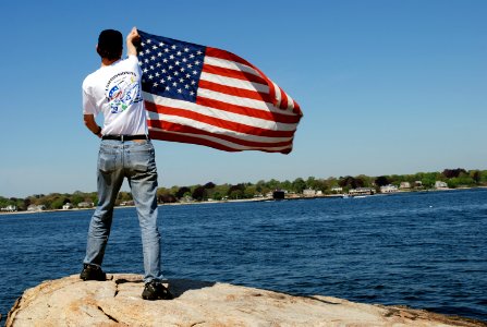 US Navy 090513-N-8750E-248 A USS Hawaii (SSN 776) crew-member's father waves a U.S. flag as the Virginia class submarine departs, enroute to its new homeport of Naval Station Pearl Harbor, Hawaii