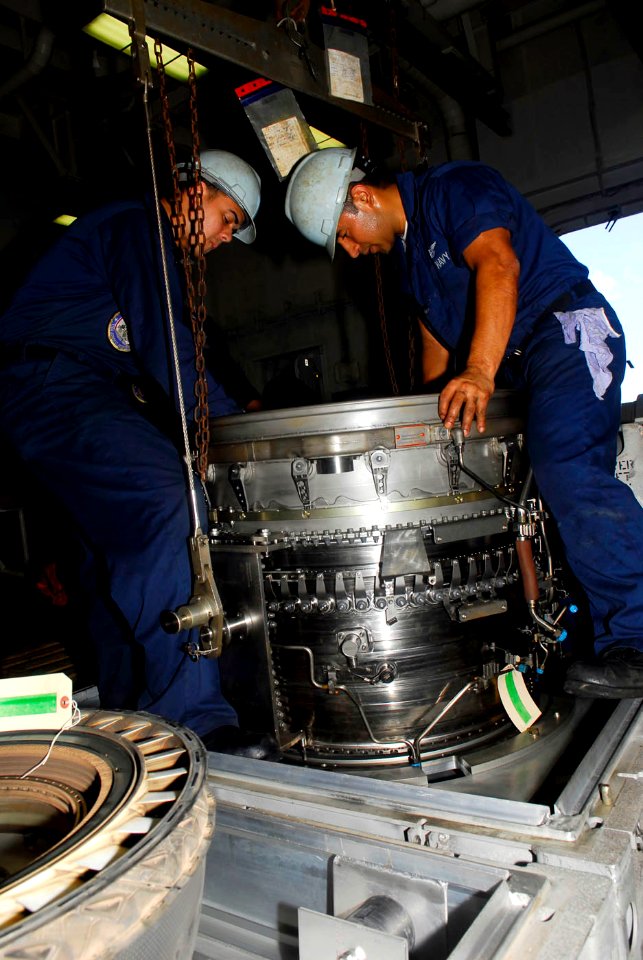 US Navy 090516-N-2475A-135 Aviation Machinist's Mate Airman Joan Medina and and Aviation Machinist's Mate 3rd Class Elman Pena perform a level III preservation on the NRFI F-414 fan module of a turbo fan engine from an F-A-18F