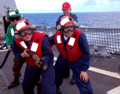 US Navy 090519-N-4047W-027 Damage Control Training Team member Senior Chief Damage Controlman Raul Sanchez supervises a hose team during a flight deck fire drill aboard the Arleigh Burke-class guided-missile destroyer USS Prebl