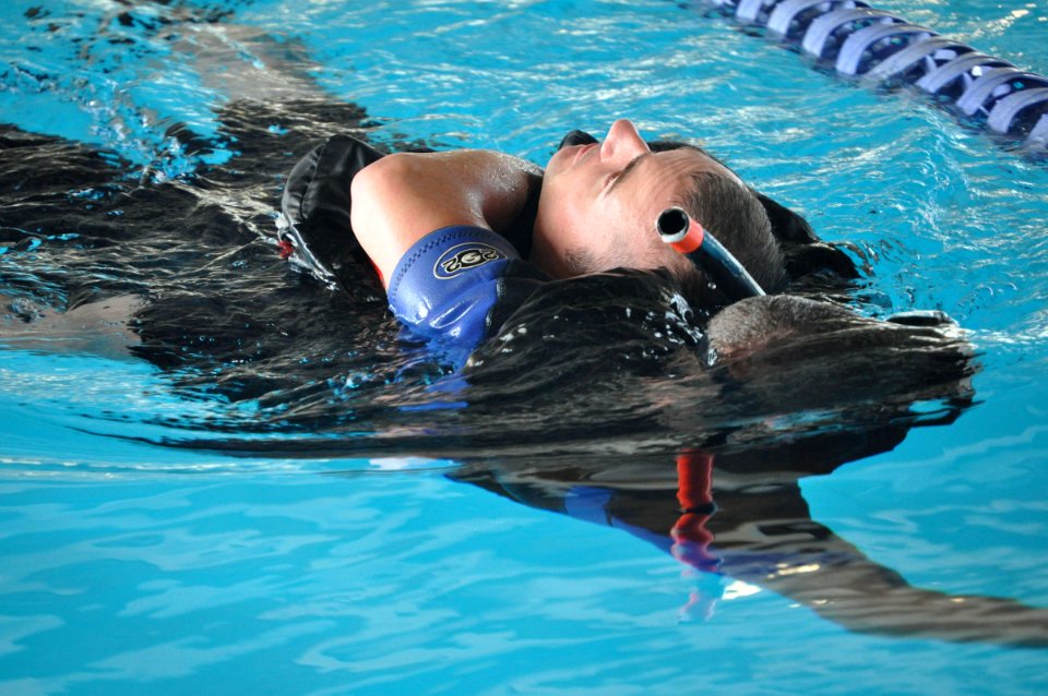 US Navy 090514-N-4124C-006 Gunner's Mate 2nd Class Bradley J. Lucas, assigned to the guided-missile cruiser USS Normandy (CG 60), pulls Electronics Technician 1st Class David J. Swasey during the swim portion of the Surface Lin