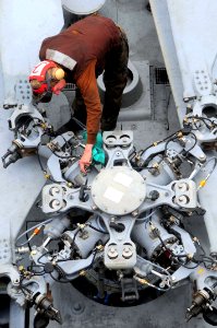 US Navy 090515-N-3946H-039 A Sailor assigned to the Indians of Helicopter Anti-Submarine Squadron (HS) 6 cleans rotor components of an SH-60F Seahawk helicopter aboard the aircraft carrier USS Nimitz (CVN 68)