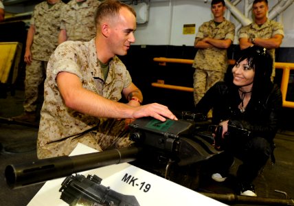 US Navy 090518-N-3595W-321 Lance Cpl. Sean Godfrey, assigned to the 26th Weapons Company, based at Camp Lejeune, N.C., gives Joan Jett, lead singer of Joan Jett and the Blackhearts, an overview of the MK-19 40mm machine gun