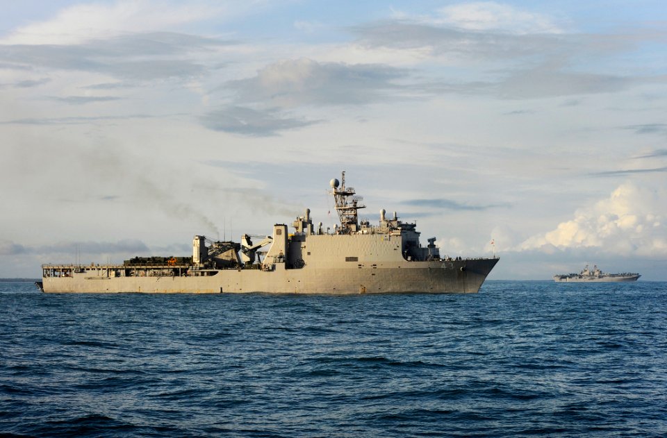 US Navy 090515-N-5345W-440 The amphibious dock landing ship USS Fort McHenry (LSD 43) is anchored off the coast of North Carolina with the amphibious assault ship USS Bataan (LHD 5) in the distance beyond her bow
