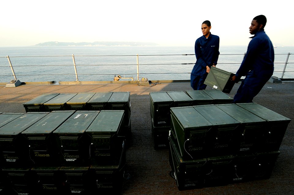 US Navy 090520-N-7478G-329 Ship's serviceman seamen Malcom Ewing and Quinton Lewis, both assigned to the amphibious command ship USS Blue Ridge (LCC 19), stack ammunition before an ammunition offload