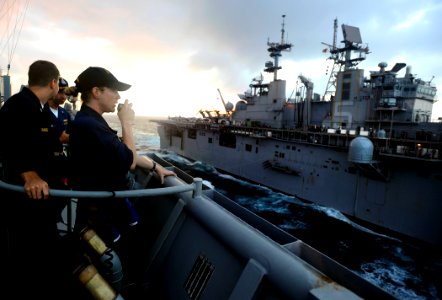 US Navy 090518-N-5345W-135 Ensign Amee Johnson, the weapons officer aboard the amphibious dock landing ship USS Fort McHenry (LSD 43), relays information to the bridge while serving as Fort McHenry's conning officer