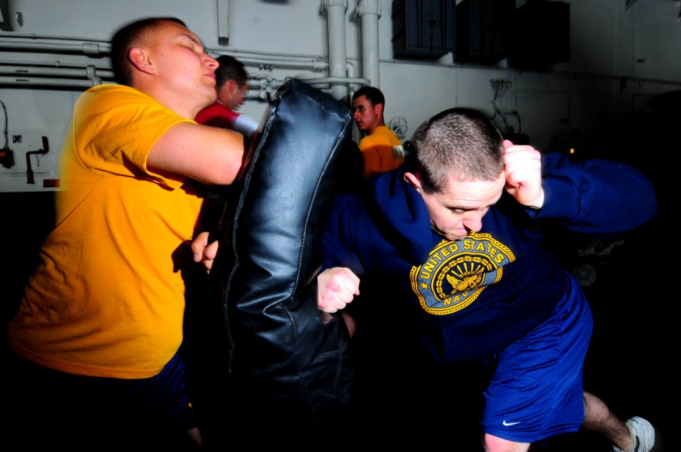 US Navy 090520-N-3946H-033 Aviation Electronics Technician 2nd Class Darren Sutherland practices take-down techniques with Aviation Boatswain's Mate (Handling) Airman Robert Matson as part of In-port Security Force training