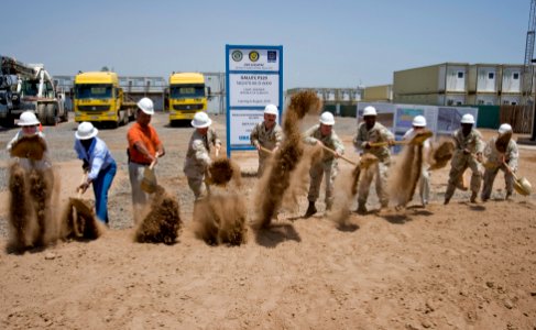 US Navy 090520-N-7526R-005 Capt. Patrick Gibbons, commanding officer of Camp Lemonier, Djibouti, Capt. William Finn, prospective camp commanding officer, and members of the URS-IAP World Services organization break ground on a
