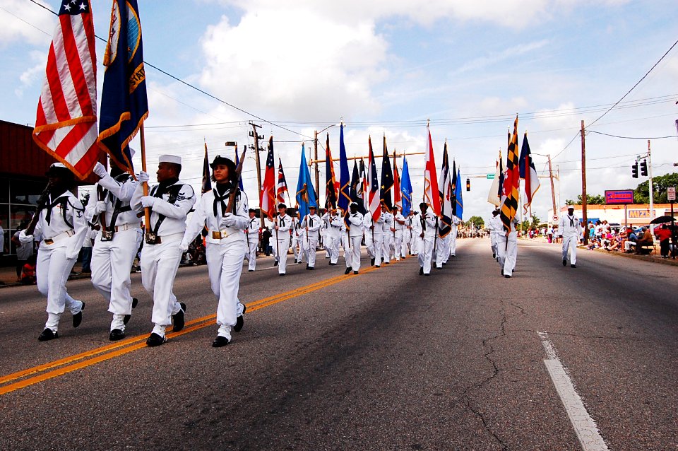 US Navy 090518-N-7239B-001 Sailors assigned to the aircraft carrier USS Theodore Roosevelt (CVN 71) carry the 50 U.S. state flags while marching on High Street in the Portsmouth Memorial Day parade
