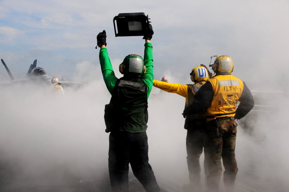US Navy 090519-N-3946H-106 Sailors assigned to the air department of the aircraft carrier USS Nimitz (CVN 68) guide an F-A-18C Hornet assigned to the