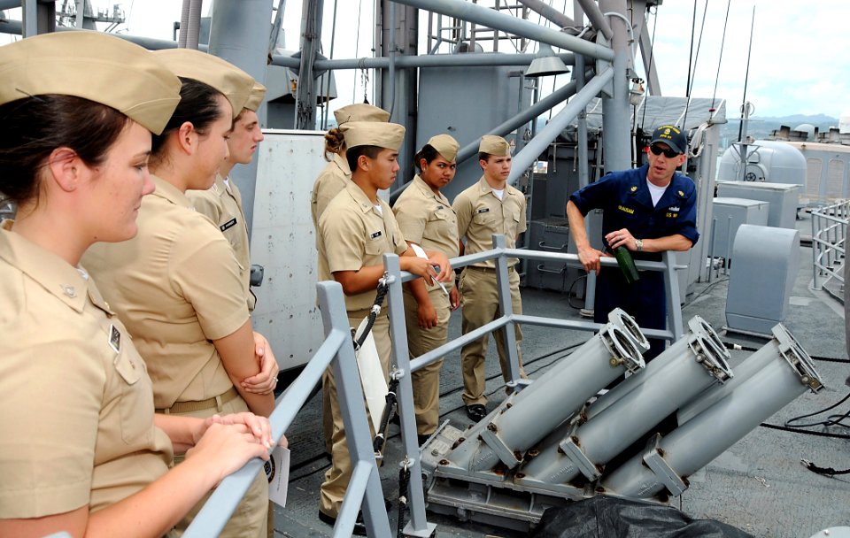 US Navy 090518-N-3666S-034 Chief Boatswain's Mate Gene Grausam explains weapons systems aboard the guided-missile frigate USS Reuben James (FFG 57) to Navy Junior ROTC cadets from Waiakea High School