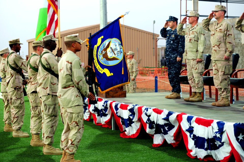 US Navy 090520-N-7526R-093 dignitaries salute the U.S. and Djiboutian flags during a change of command ceremony at Camp Lemonier
