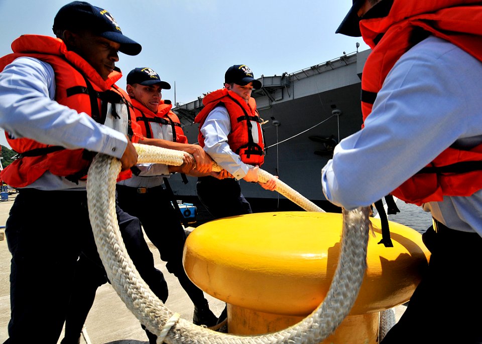 US Navy 090520-N-2638R-002 Sailors remove a mooring line from a bollard as the aircraft carrier USS George Washington (CVN 73) departs Commander, Fleet Activities Yokosuka for a scheduled underway