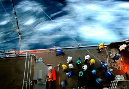 US Navy 090518-N-5345W-160 Deck department Sailors aboard the amphibious dock landing ship USS Fort McHenry (LSD 43) bring across a fuel line while conducting a refueling at sea with the amphibious assault ship USS Bataan (LHD