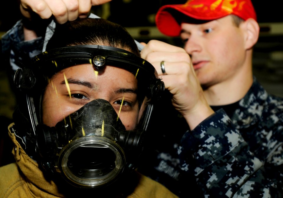 US Navy 090518-N-3595W-054 A student from Westbury High School in Long Island, N.Y. enrolled in the U.S. Naval Sea Cadet program tries on fire-fighting gear