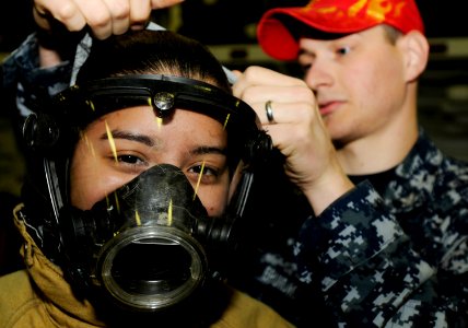 US Navy 090518-N-3595W-054 A student from Westbury High School in Long Island, N.Y. enrolled in the U.S. Naval Sea Cadet program tries on fire-fighting gear