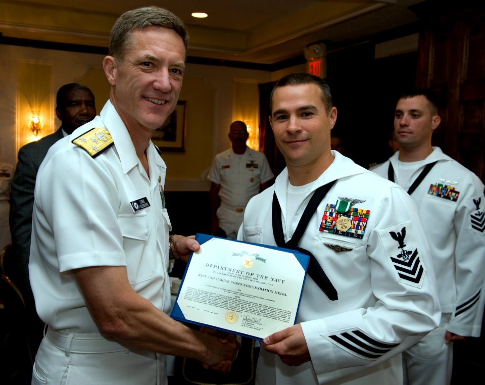 US Navy 090521-N-1722M-120 Chief of Navy Reserve Vice Admiral Dirk Debbink presents the Navy and Marine Corps Commendation Medal to Naval Aircrewman 1st Class William J. Frost, assigned to Helicopter Sea Combat Squadron (HSC) 8
