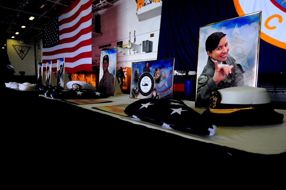 US Navy 090523-N-3946H-003 Pictures of departed crewmembers are displayed during a memorial service in the hangar bay of the aircraft carrier USS Nimitz (CVN 68)