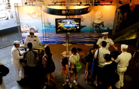 US Navy 090522-N-7676W-243 Cmdr. Dan Billow, left, and Cmdr. James Devers, from the Office of Naval Research (ONR), discuss future technologies with visitors and Sailors aboard the amphibious assault ship USS Iwo Jima (LHD 7)