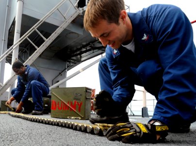 US Navy 090523-N-5345W-117 Gunner's Mate 3rd Class Sean O'Brien, right, and Gunner's Mate 2nd Class Danny Artis, left, race each other while loading 20mm dummy rounds into a Phalanx Close-In Weapons System