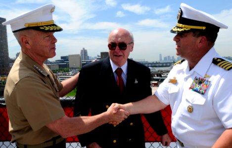 US Navy 090522-N-3595W-159 Gen. James F. Amos, assistant commandant of the U.S. Marine Corps and Capt. Jeffery Amick shake hands as Battle of Iwo Jima veteran Allen Striffler looks on after a wreath laying ceremony