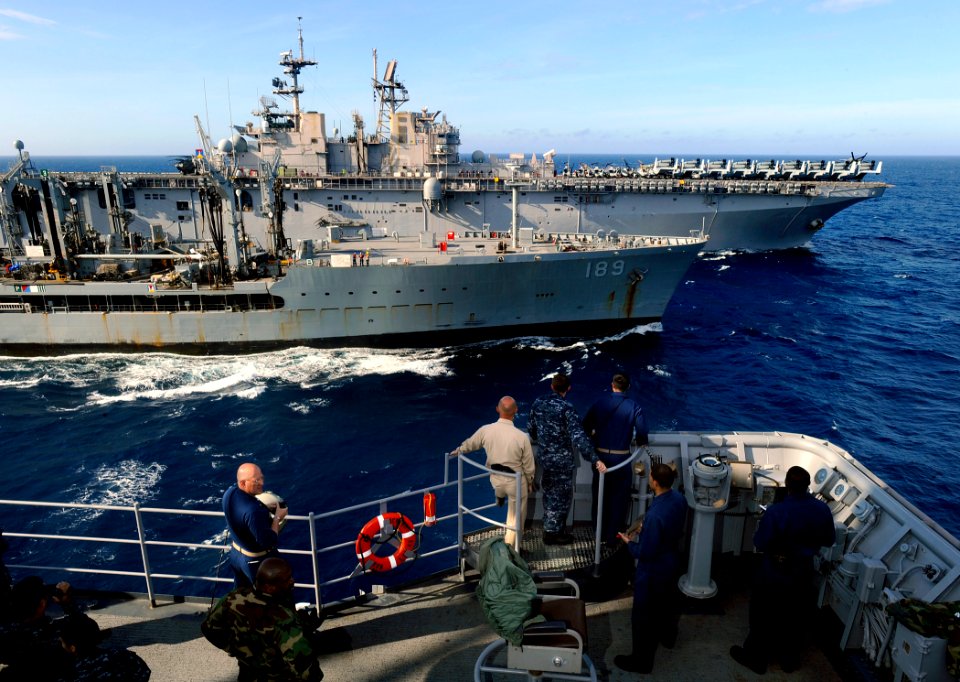 US Navy 090523-N-5345W-307 Sailors aboard the amphibious dock landing ship USS Fort McHenry (LSD 43) watch from the conning station as the military sealift command fleet replenishment oiler USNS John Lenthall (T-AO 189), center