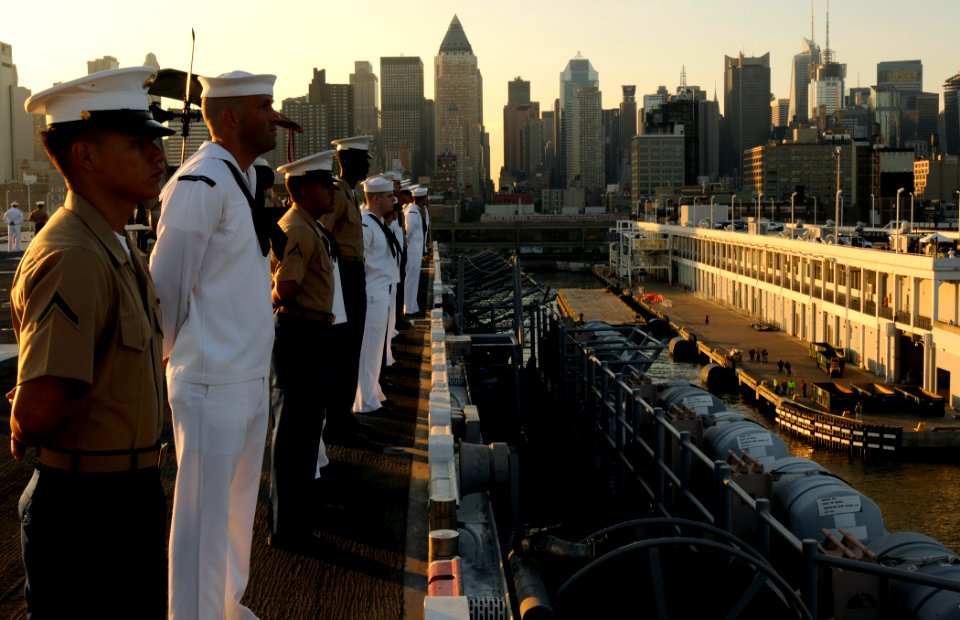 US Navy 090520-N-3595W-101 Sailors and Marines man the rails on the flight deck of the amphibious assault ship USS Iwo Jima (LHD 7), as the ship prepares to dock at pier 88 in Manhattan