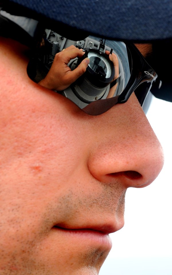 US Navy 090523-N-5345W-127 Enisgn Rob Druce, 2nd Division officer aboard the amphibious dock landing ship USS Fort McHenry (LSD 43), checks the ship's course on a magnetic compass