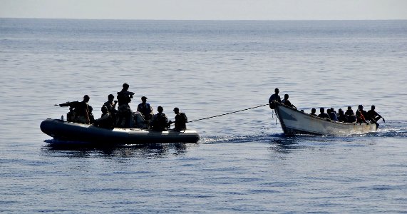 US Navy 090524-N-4774B-054 Members of the visit, board, search, and seizure team from the guided-missile cruiser USS Lake Champlain (CG 57) tow a disabled skiff carrying 52 Somali migrants photo
