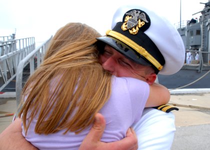 US Navy 090523-N-0486G-009 Lt. j.g. Dallas Gates embraces his daughter after his return from a six-month deployment aboard the guided-missile frigate USS Robert G. Bradley (FFG 49) as she returns home to Mayport Naval Station