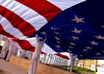 US Navy 090522-N-0780F-001 Sailors open an American flag before a Naval Support Activity Souda Bay Memorial Day event