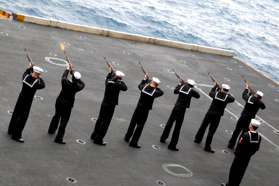 US Navy 090523-N-1786N-060 Members of the aircraft carrier USS Nimitz (CVN 68) honor guard fire a rifle volley during a memorial service in the hangar bay