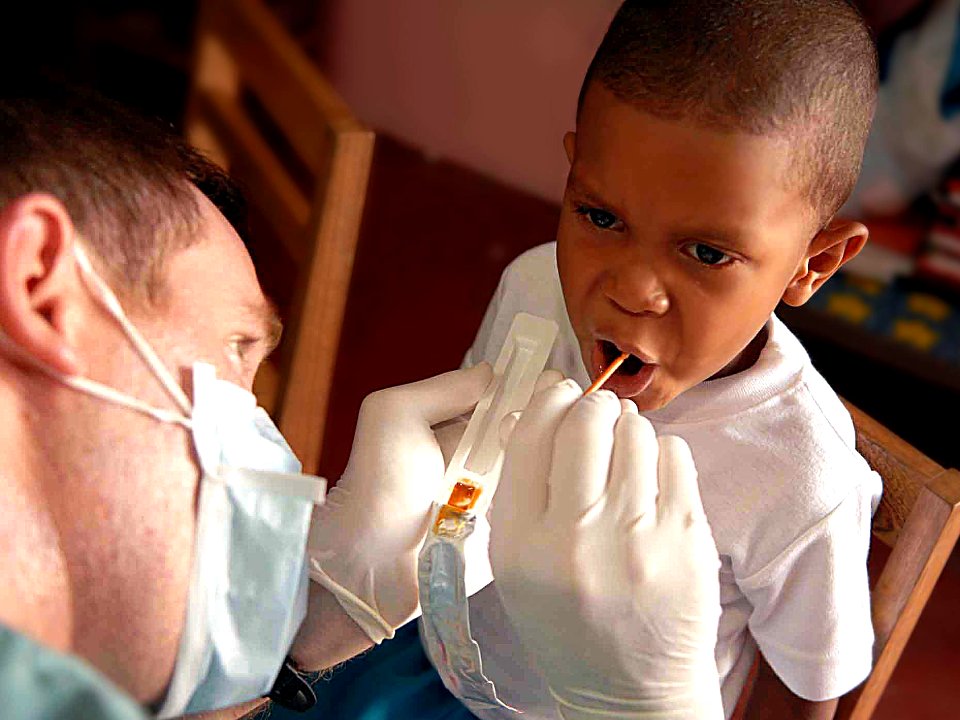 US Navy 090526-F-1333S-023 A service member embarked aboard the Military Sealift Command hospital ship USNS Comfort (T-AH 20) gives a Fluoride treatment to a patient during a Continuing Promise 2009 medical civil service projec