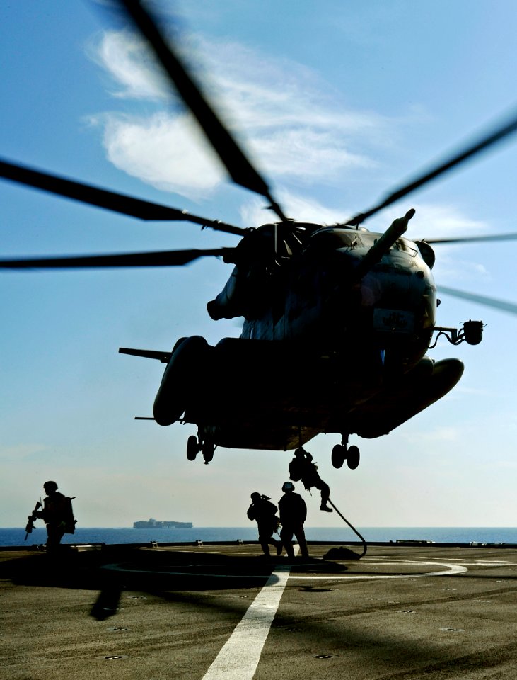 US Navy 090526-N-5345W-060 Marines from the 22nd Marine Expeditionary Unit (22 MEU) fast-rope from a CH-53 Super Stallion to the flight deck of the amphibious dock landing ship USS Fort McHenry (LSD 43)