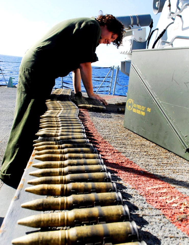 US Navy 090524-N-1226D-111 Fire Controlman 2nd Class Kate Vohs, from Spencer W. Va., links 20mm dummy rounds for use in a Close-in Weapon System aboard the guided-missile destroyer USS Preble (DDG 88)