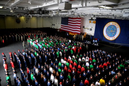 US Navy 090523-N-1786N-056 Sailors aboard the aircraft carrier USS Nimitz (CVN 68) stand at attention for a rifle volley during a memorial service in the hangar bay