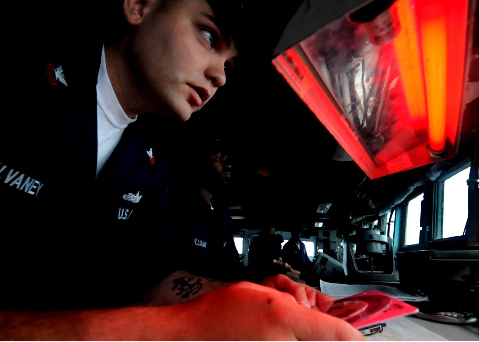 US Navy 090522-N-7478G-067 Quartermaster 1st Class Daniel McElvaney, assigned to the amphibious command ship USS Blue Ridge (LCC 19), charts a course for Yokosuka