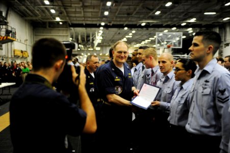 US Navy 090525-N-0684R-039 Capt. Joseph Kuzmick, commanding officer of the aircraft carrier USS John C. Stennis (CVN 74), poses for a photo with newly frocked Sailors