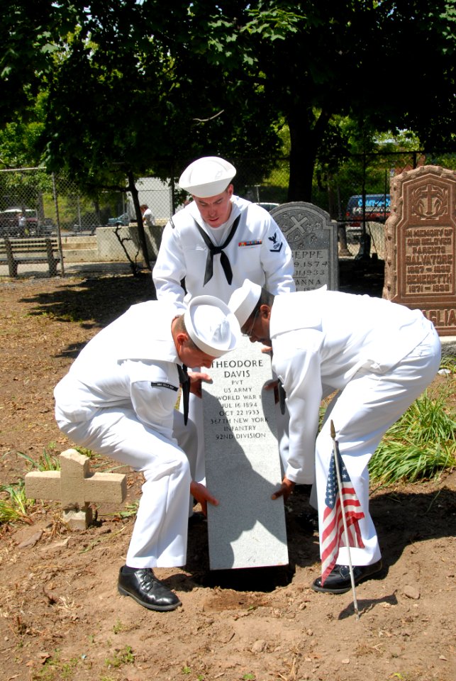 US Navy 090522-N-4936C-073 Sailors assigned to the guided-missile cruiser USS Vella Gulf (CG 72) place a new headstone for a World War I veteran at Lake Cemetery in Staten Island