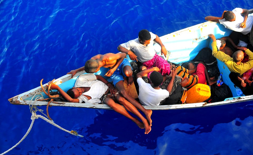 US Navy 090525-N-4774B-032 Somali migrants in a disabled skiff wait for assistance from Sailors aboard the guided-missile cruiser USS Lake Champlain (CG 57)