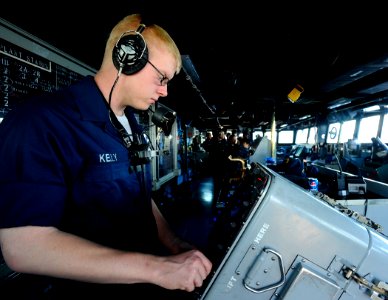 US Navy 090523-N-5345W-329 Operations Specialist Seaman Nicholas Kelly mans the ANSPA 25G radar station in the pilothouse of the amphibious dock landing ship USS Fort McHenry (LSD 43) photo