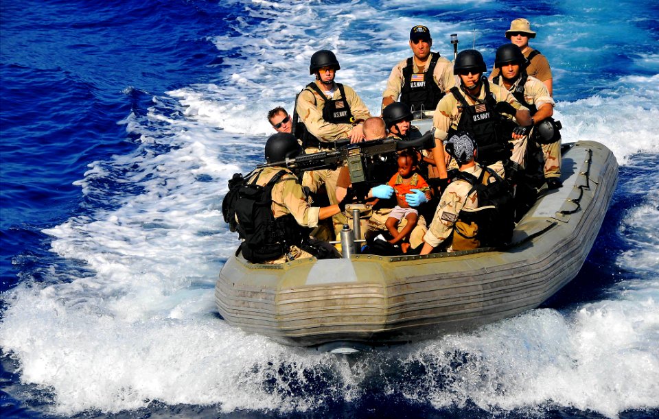 US Navy 090524-N-4774B-063 Members of the visit, board, search, and seizure team transport Somali migrant children to the guided-missile cruiser USS Lake Champlain (CG 57) after being rescued from a disabled skiff
