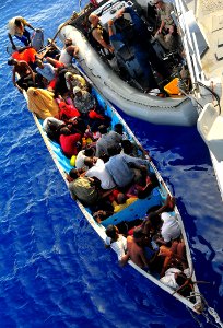 US Navy 090525-N-4774B-044 Somali migrants in a disabled skiff receive assistance from Sailors aboard the guided-missile cruiser USS Lake Champlain (CG 57)
