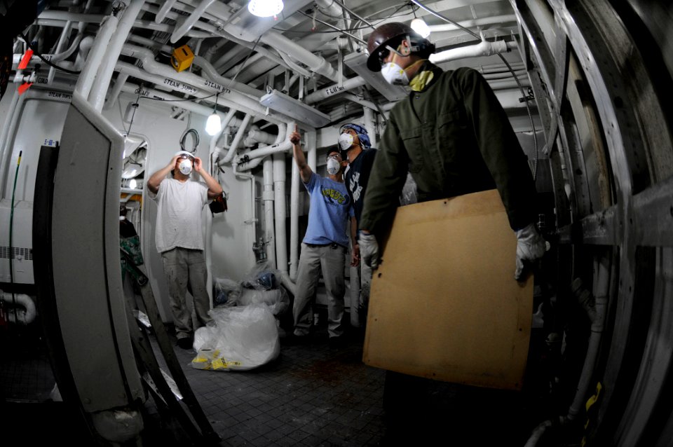 US Navy 090528-N-3830J-008 A member of the local ship repair facility team removes a mirror out of the 7th Fleet staff berthing spaces aboard the amphibious command ship USS Blue Ridge (LCC 19)